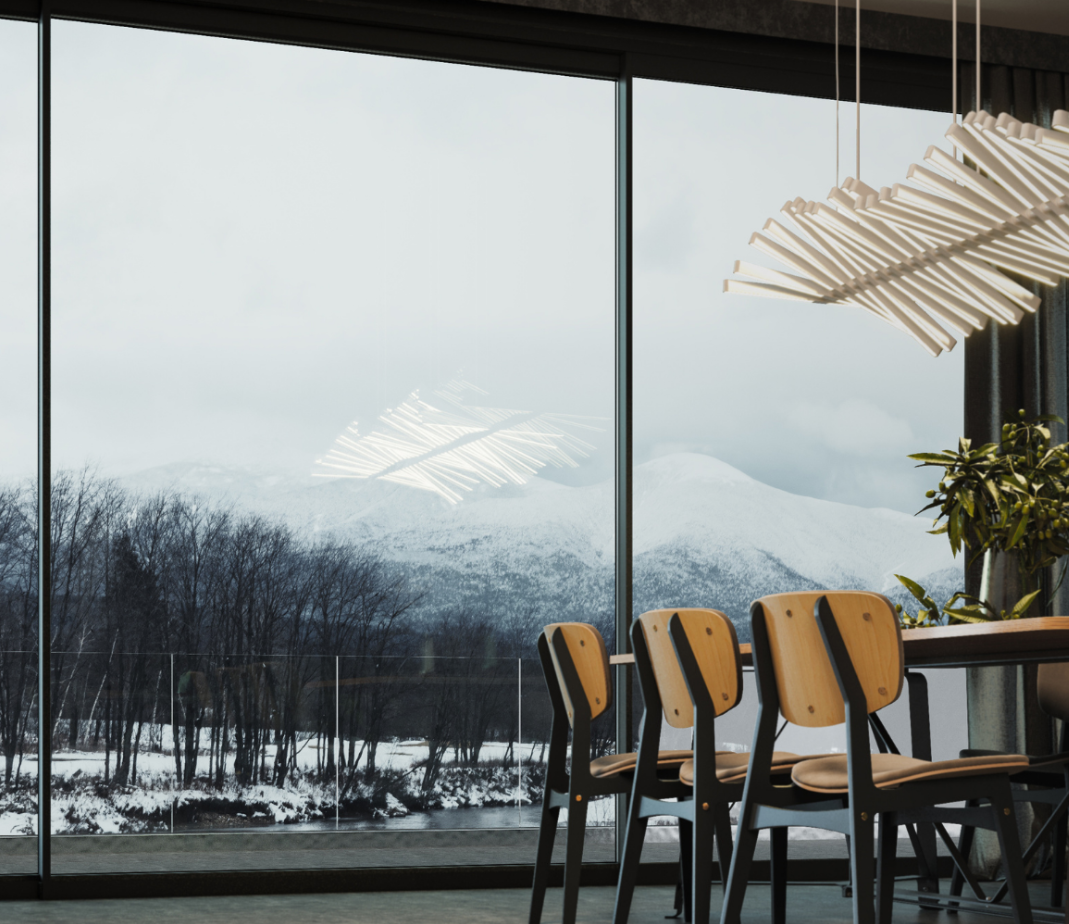 black bi folding doors in the dining room with a winter landscape