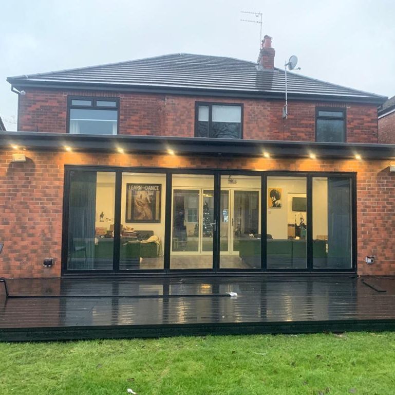 6 leaf bi folding doors in black featuring a black patio